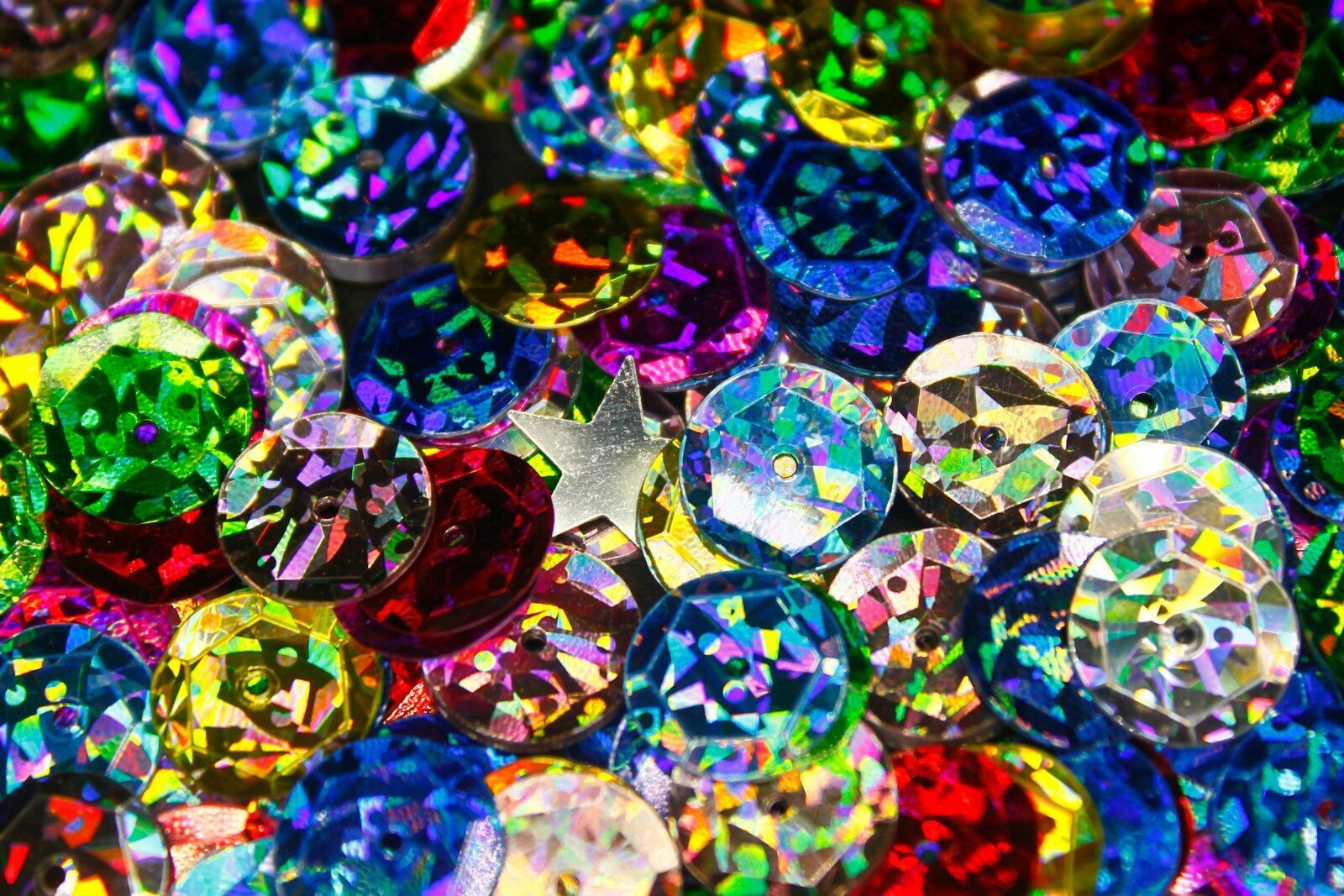 a pile of colorful jewel stones sitting on top of a table