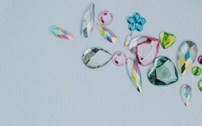 a group of different colored stones on a white surface