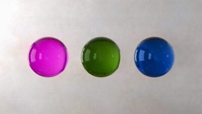 three different colored balls are in a row